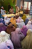 Local women with Bourqa receiving bread, Peshawar, Pakistan